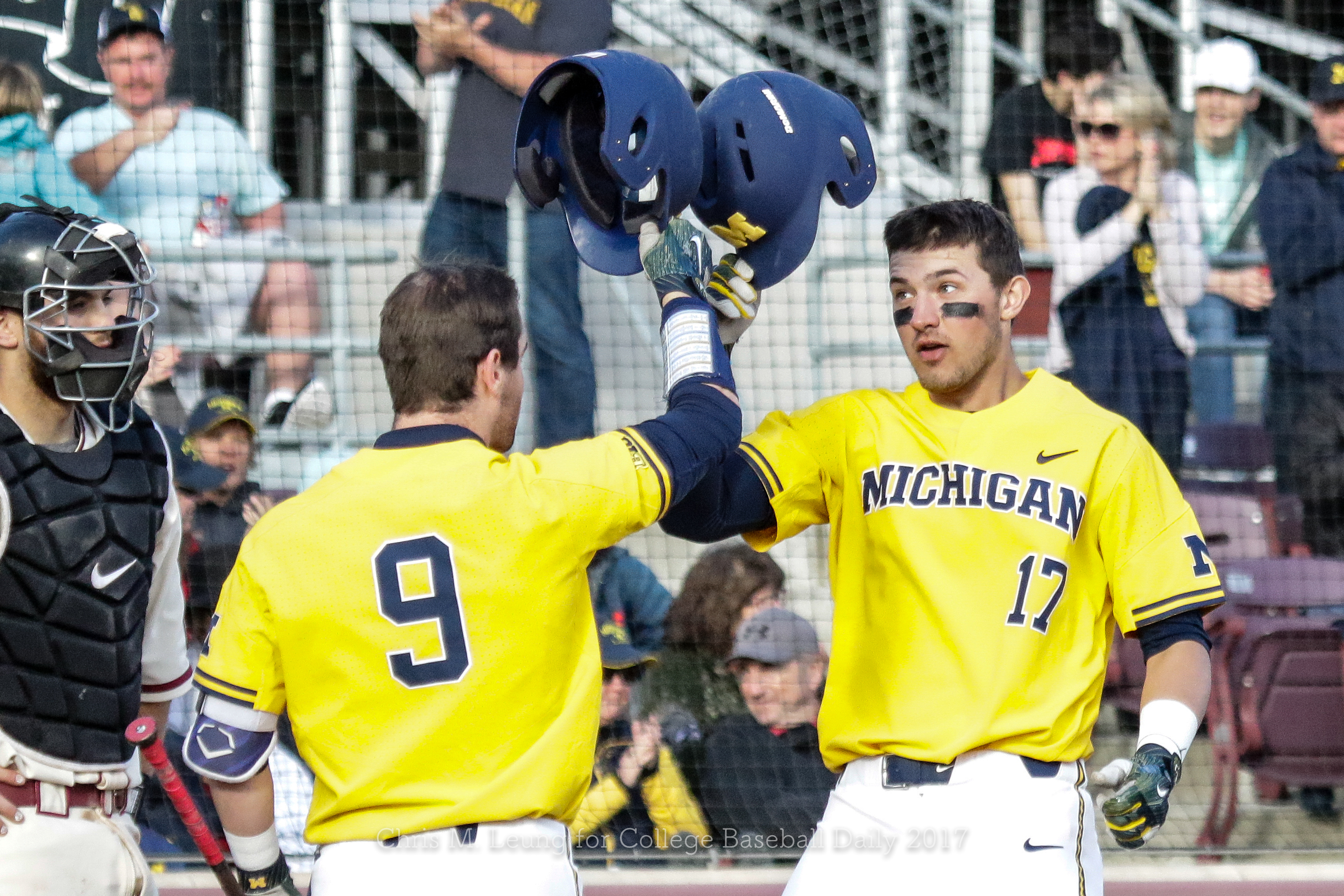 Michigan Wolverines third baseman Drew Lugbauer (17) and pitcher